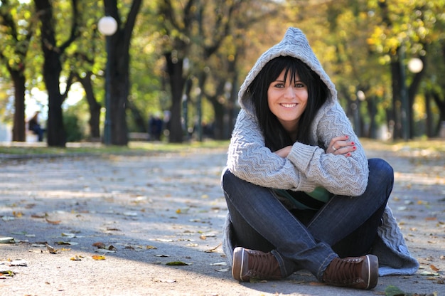 Jolie jeune femme souriante à l'extérieur dans la nature