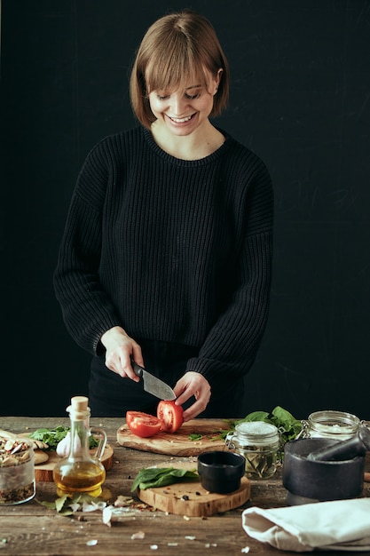 Jolie jeune fille cuisine dans une cuisine confortable