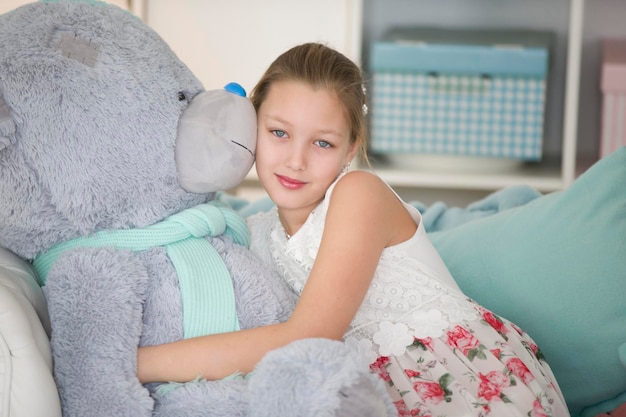 Jolie petite fille avec un énorme ours en pelucheBelle adolescente avec une peluche