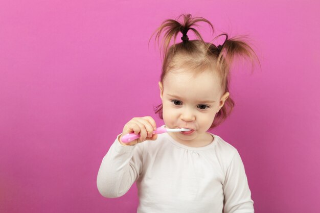 Jolie petite fille se brosser les dents. Vue de dessus