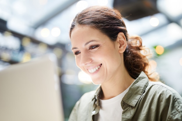 Jolly woman using modern device