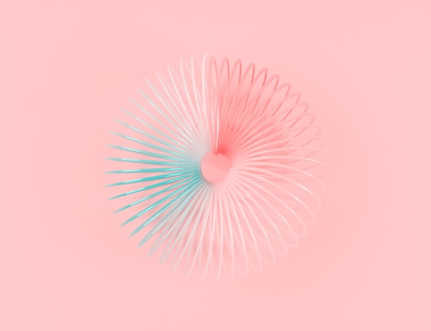 Jouet en plastique spirale arc-en-ciel coloré sur fond rose
