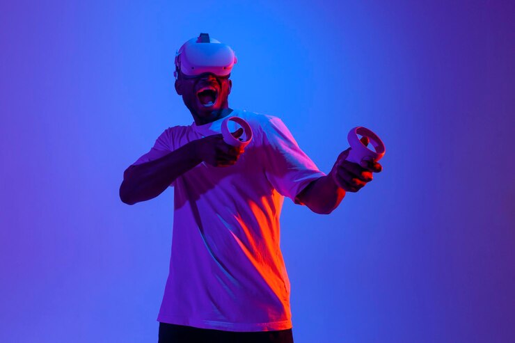 Photo un joueur afro-américain choqué dans des lunettes de réalité virtuelle tire et vise avec des joysticks