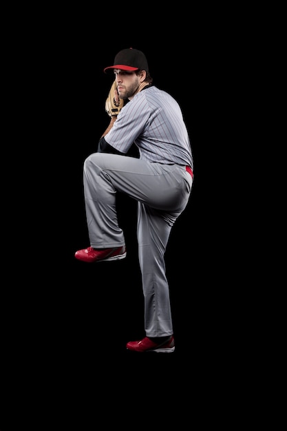 Joueur de baseball lancer une balle. Prise de vue en studio.