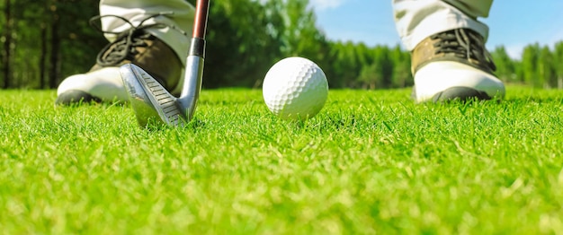 Joueur de golf au putting green frappant la balle dans un trou