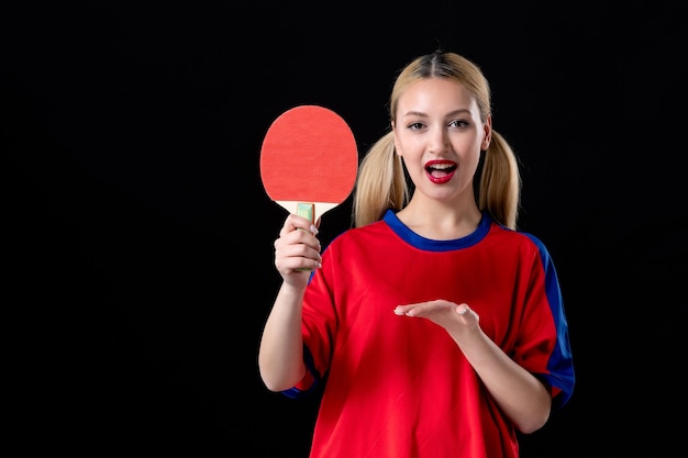 Joueuse avec raquette de tennis de table sur fond noir sport athlète jeu