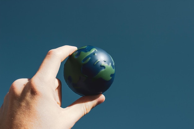 Jour de la Terre. Main masculine tenant la terre dans ses mains. Sauver la planète Terre humaine.