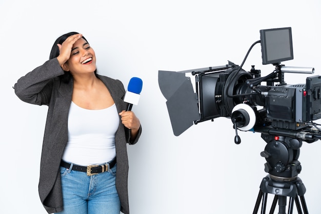 Une journaliste tenant un microphone et rapportant des nouvelles sur le mur blanc a réalisé quelque chose et a voulu la solution