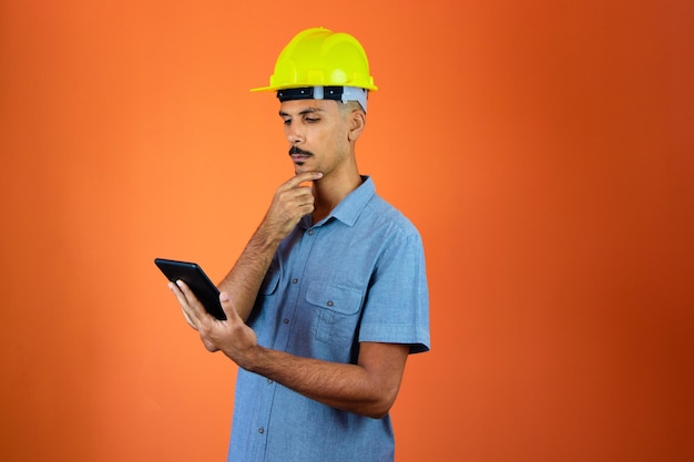 Journée des ingénieurs Black Man in Safety Helmet and Blue Shirt isolé Engineer Holding Mobile