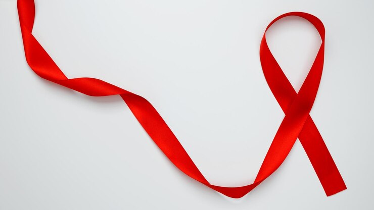 Photo journée mondiale du sida ruban rouge avec une sensibilisation au sida sur un fond blanc