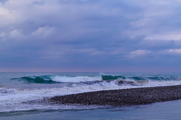 Photo une journée nuageuse en mer des vagues sur la plage