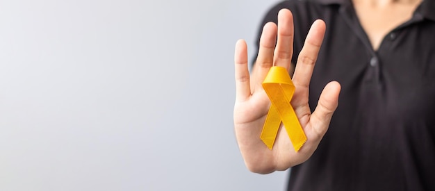 Journée de prévention du suicide Enfance Sarcome os et cancer de la vessie Mois de sensibilisation Ruban jaune pour soutenir la vie et la maladie des enfants Santé et concept de la Journée mondiale du cancer