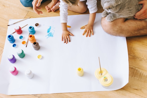 Joy famille art heureux père mère et fils montrer les mains dans des couleurs vives peindre ensemble photo artgether art