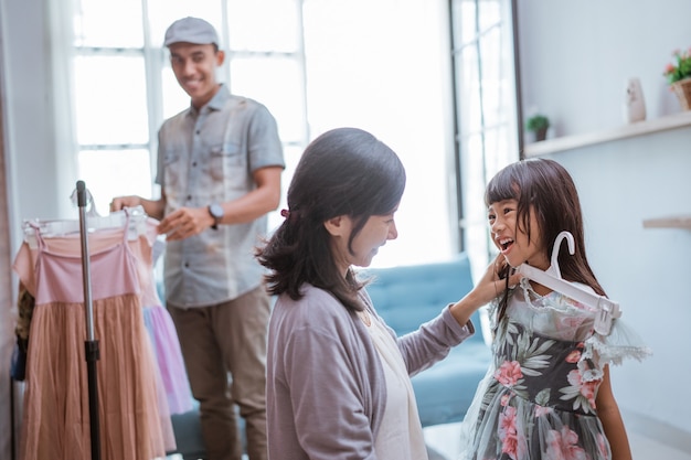 Joyeuse famille asiatique faisant du shopping ensemble dans le magasin de vêtements