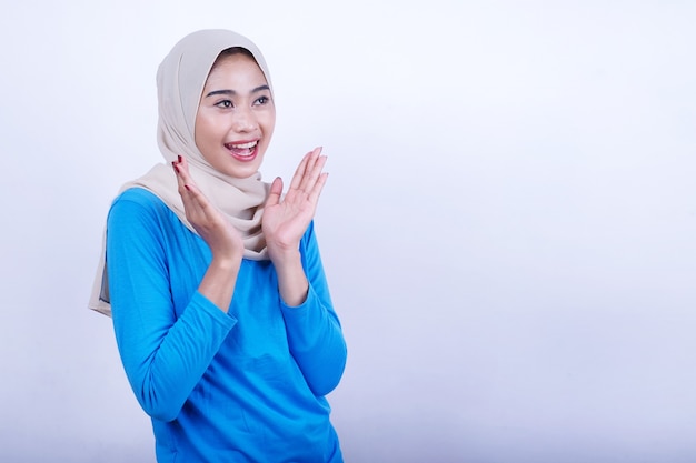 Joyeuse jeune femme avec t-shirt bleu portant une expression surprenante hijab