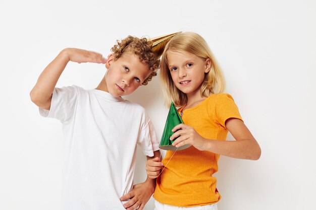 Joyeux enfants posant des émotions vacances casquettes colorées fond isolé inchangé