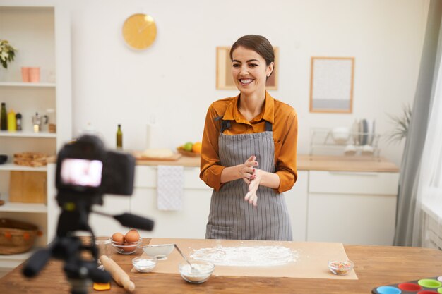 Joyful Woman Filming Baking Video in Kitchen