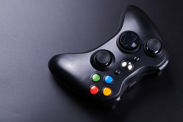 Joystick de contrôleur de jeu vidéo noir pour console de jeu isolé sur fond noir gros plan de l'appareil de contrôle Gamer