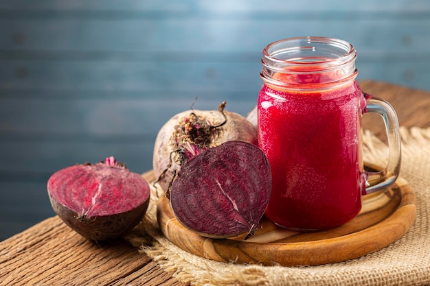 Jus de betterave rouge dans une tasse en verre sur la table en bois