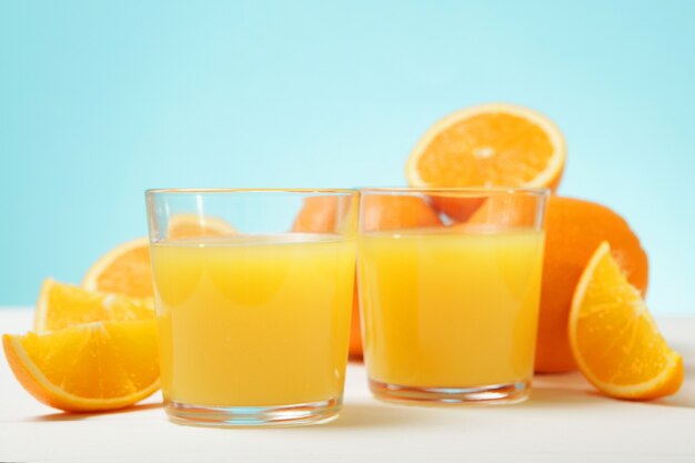 Jus d'orange dans un verre d'oranges et de tranches d'orange sur la table