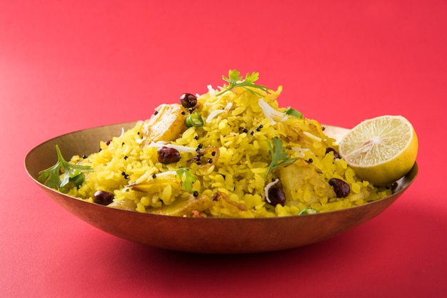 Kande Pohay OU Aloo Poha est une recette de petit-déjeuner indien populaire à base de riz aplati, généralement servi avec du thé chaud. Servi dans un bol dessus. Mise au point sélective
