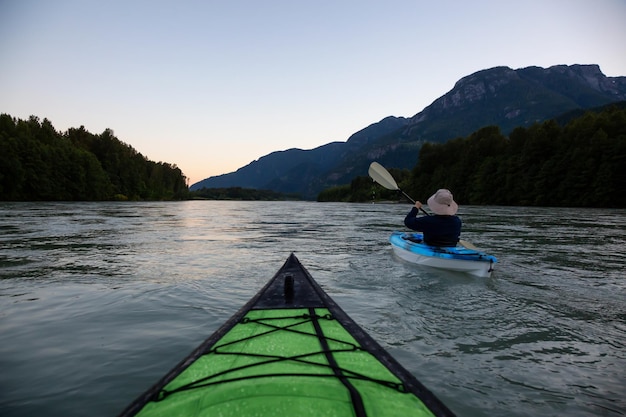 Kayak dans une rivière entourée de montagnes canadiennes