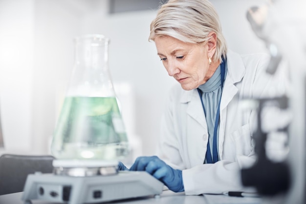 Laboratoire scientifique senior et bécher pour l'analyse de l'étude et la concentration pour un emploi dans l'industrie pharmaceutique Laboratoire scientifique et travail avec la recherche pharmaceutique pour l'avenir de la vision ou l'analyse en Suède