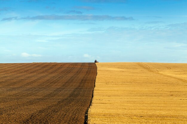 Labourer le sol d'un tracteur après la récolte du blé