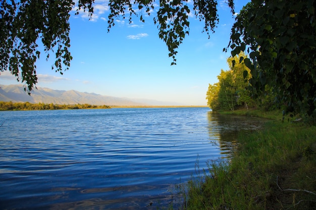 Lac dans les montagnes Baie tranquille dans la verdure au coucher du soleil Lieu de repos Kirghizistan Lac IssykKul