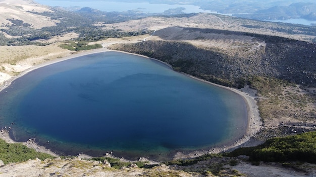 Photo un lac dans les montagnes avec un ciel bleu et une montagne en arrière-plan