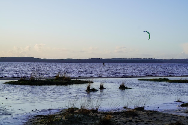 Lac de Lacanau man in kitesurf beach sunrise en Aquitaine France