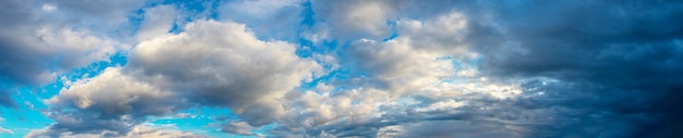 Large panorama avec des nuages blancs et sombres dans un ciel dramatique. Temps instable