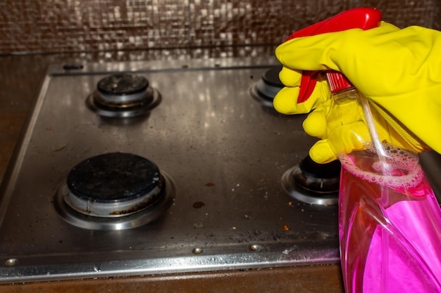 Lave la cuisinière à gaz avec un spray