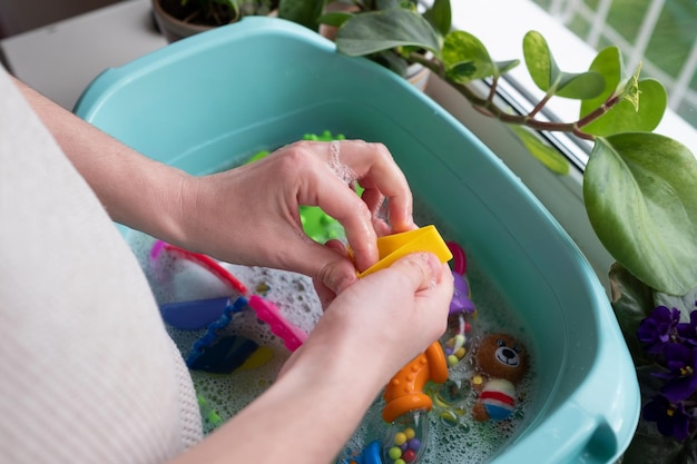 Laver les jouets en plastique pour enfants des microbes et de la saleté. Concept d'hygiène des enfants