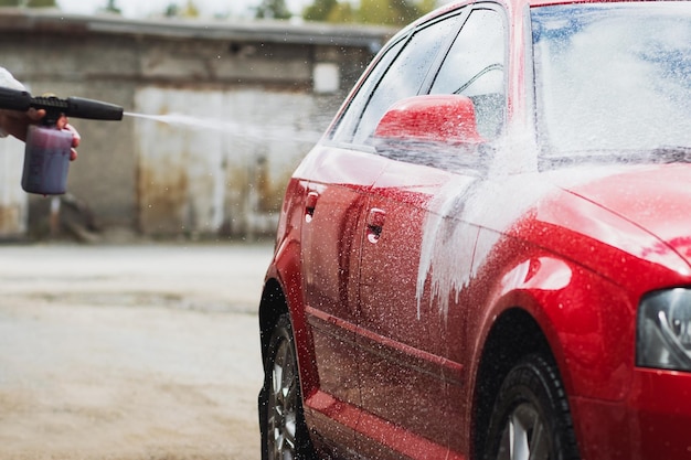 La laveuse provoque du shampoing sur la voiture