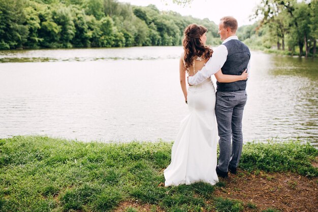 Élégante mariée et le marié posant ensemble à l'extérieur un jour de mariage