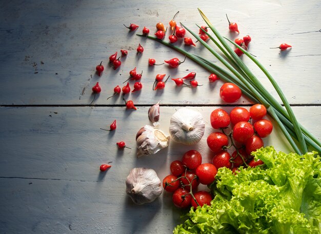 Légumes et épices sur une table avec lumière naturelle et vue de dessus.
