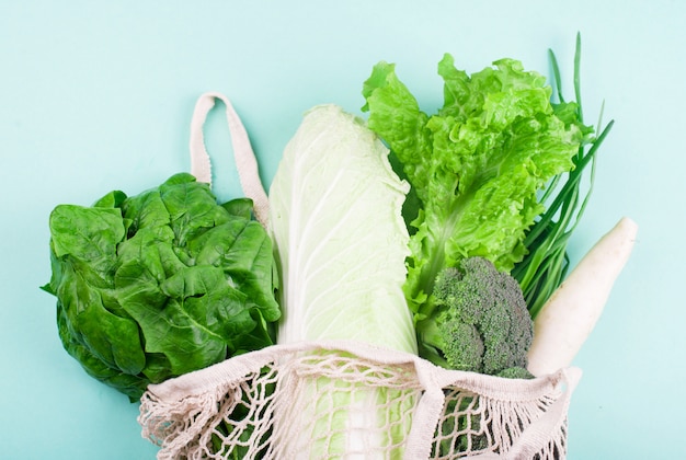 Légumes, feuilles d'épinards, laitue, oignons verts, radis, chou dans un sac à provisions pour aliments. Zero gaspillage