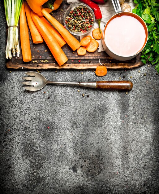 Légumes frais. Légumes frais aux épices, herbes et jus de carotte sur table rustique.