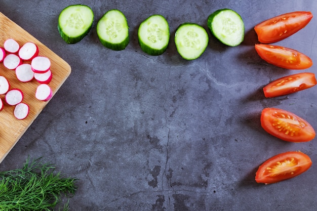 Légumes pour la salade: concombres, tomates, radis, oignons verts et aneth.