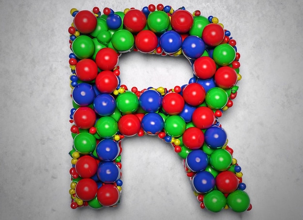 Une lettre r faite de boules colorées est montrée sur une photo.