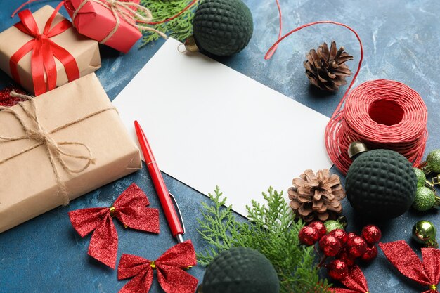 Lettre vierge au Père Noël et décor de Noël sur béton bleu, vue du dessus