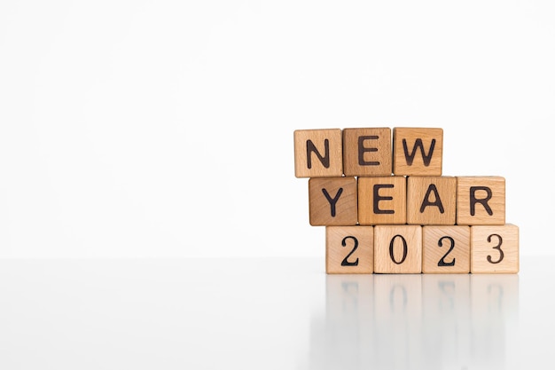 lettres de l'alphabet du Nouvel An 2023 sur fond blanc de cubes en bois