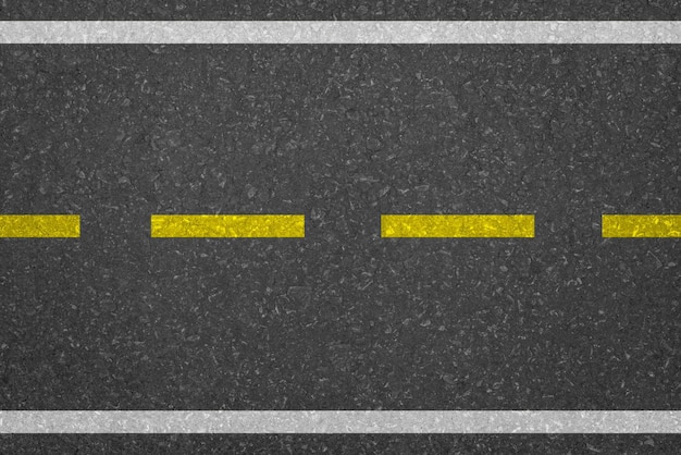 Ligne jaune sur la texture de la route d'asphalte