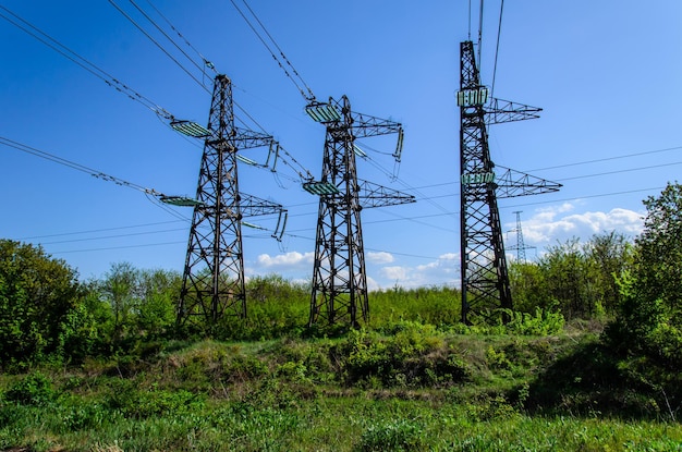 Lignes à haute tension et tours contre le ciel bleu