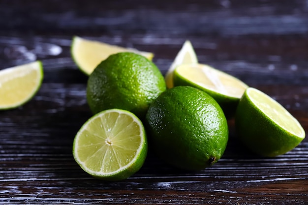 Limes et tranches de limes sur un fond en bois foncé