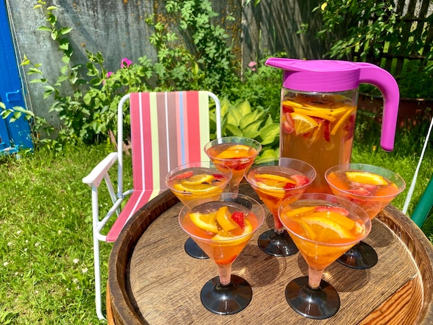 limonade aux fruits d'été dans des verres à l'extérieur sur une table en bois