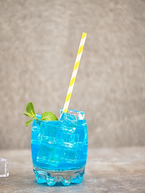 Limonade bleue dans un verre avec de la glace