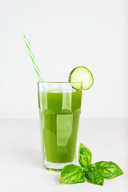 Limonade de concombre frais au basilic dans un verre sur tableau blanc