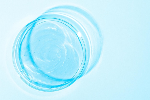Liquide bleu avec lustre Dans une boîte de Pétri Recherche en laboratoire de médecine de gel cosmétique Chimie